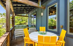 a patio with a table and chairs on a deck at Tickle Me Tides in Inlet Beach