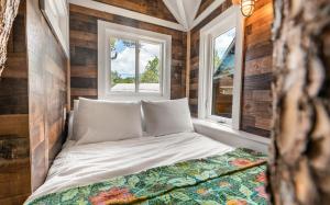 a bed in a tiny bedroom with two windows at Tickle Me Tides in Inlet Beach +129 photos