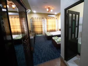 a room with two beds and a room with a mirror at Tan Tay Do Hotel in Can Tho