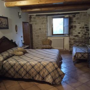 a bedroom with two beds and a window at Raggio Campacci di Sacchetti Vanessa in Rovereti +28 photos