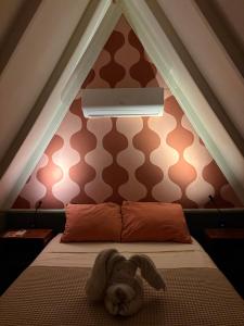 a dog laying on a bed in a room at Casa Balam Holbox, Beach style cabañas in Holbox Island