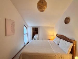 a bedroom with a bed and a window at Grace House in Marina di Sorso