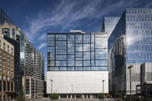 a tall building with glass windows in a city at Hyatt Centric Downtown Nashville in Nashville