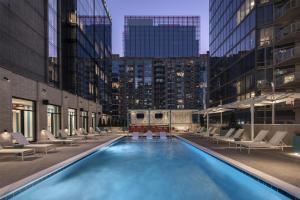 a swimming pool with lounge chairs in a building at Hyatt Centric Downtown Nashville in Nashville