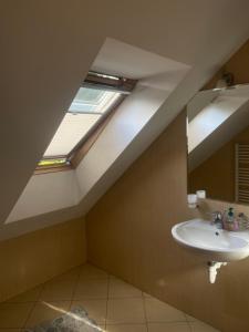 a bathroom with a sink and a skylight at Willa Faustynka in Nałęczów +54 photos