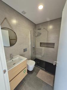 a bathroom with a shower and a sink and a toilet at Ribavilla Surf House in Santo Isidoro +16 photos