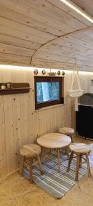 a room with tables and benches in a cabin at Maringotka pod hvozdem in Spešov