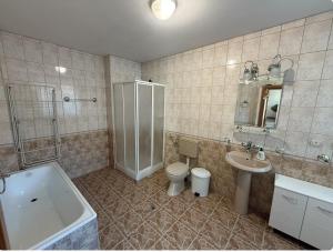 a bathroom with a toilet and a shower and a sink at Guest House Скиора in Chepelare +10 photos