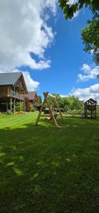 a park with a swing set in the grass at Beržoro pakrantė in Berżory +16 photos