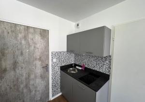a kitchen with a sink and a counter top at Studio Quartier Amiens in Amiens