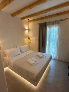 a bedroom with a bed with two towels on it at Golden Star in Ios Chora +104 photos