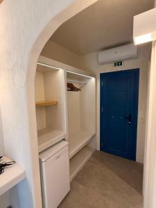a walk in closet with a blue door at Golden Star in Ios Chora