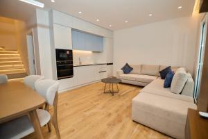 a living room with a couch and a table at Blue Golem Durres Albania in Golem