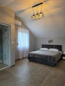 a bedroom with a bed and a chandelier at Eagle’s Nest in Shkodër +112 photos