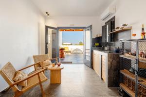 a kitchen with a table and chairs in a room at iL Fagiolo Suites in Vourvoúlos
