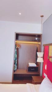 a bedroom with a bed and a desk in a room at APEC Mandala Mũi Né Official - Diễm Phạm Travel in Phan Thiet +50 photos