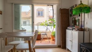 a kitchen with a table and a view of a balcony at Aguas de Mar in Castillo de BaÃ±os
