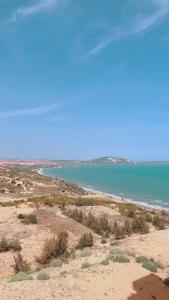 a view of a beach with a body of water at APEC Mandala Mũi Né Official - Diễm Phạm Travel in Phan Thiet