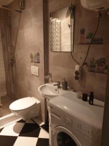 a bathroom with a washing machine and a sink at Hutnicza 54 in Poznań