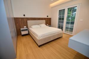 a bedroom with a bed and a large window at Blue Golem Durres Albania in Golem +35 photos