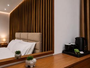 a hotel room with a bed and a mirror at Dine Hotel in Ksamil