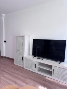 a living room with a large flat screen tv at Orinoco 20 in Nigrán
