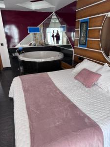 a bedroom with a large bed and a bath tub at Orinoco 20 in Nigrán