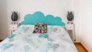a bedroom with a bed with a blue headboard at Aguas de Mar in Castillo de BaÃ±os
