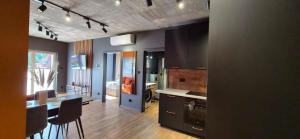 a kitchen and dining room with a table and chairs at Apartament Baltic 13 Mielno in Mielno