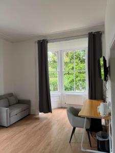a living room with a couch and a window at OX Hotel Spean Bridge in Spean Bridge