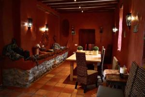 a restaurant with a table and chairs in a room at Torre de Arriba Casa Rural in Benimantell