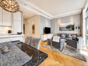 a living room with a couch and a table at Ferienwohnung Luxus Sonnensuite in der Strandvilla Charlotte Binz in Binz