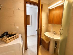 a bathroom with a sink and a toilet and a door at MK Seaview Stays in Neos Marmaras