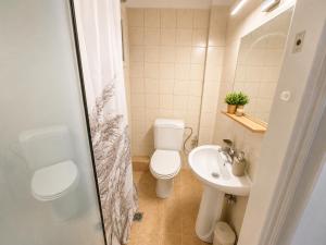 a bathroom with a toilet and a sink at Aurora Apartments Stavros in Stavros +18 photos