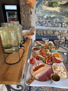 a table with many different types of food on it at Panorama View Holiday Home in Šušanj