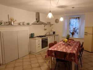 a kitchen with a table with a bowl of fruit on it at La Corte della Musica in Roppolo