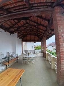 a large patio with tables and chairs and a brick building at La Corte della Musica in Roppolo