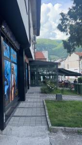 a building with a sidewalk in front of a building at Golden Apartment in Travnik