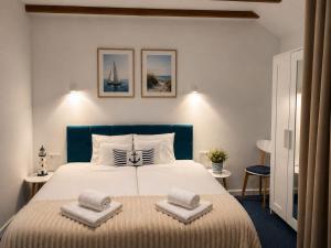 a bedroom with a large bed with two pillows on it at Apartamenty Na Fali in Jastarnia