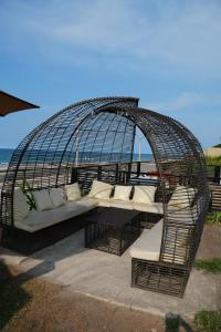 a bird cage with couches and pillows in it at The Coast By RAD in Talisay