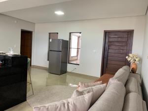 a living room with a couch and a refrigerator at Casa 161 in Diamantina