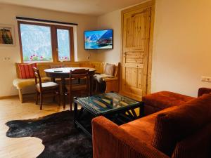 a living room with a couch and a table at Unterhecherhof in Bannberg
