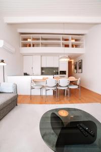 a kitchen and living room with a table and chairs at Micah's Biscainhos Apartment by Quantique in Braga