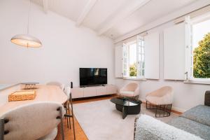 a living room with a couch and a table at Micah's Biscainhos Apartment by Quantique in Braga