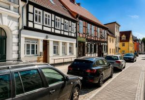 a group of cars parked on a street with buildings at Stendaler Apartments in Stendal