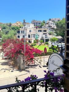 a view of a city from a balcony with flowers at Al porto in Àrbatax