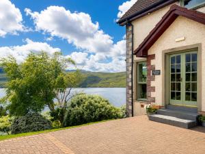 a house with a view of a lake at Ardvreck House in Ullapool