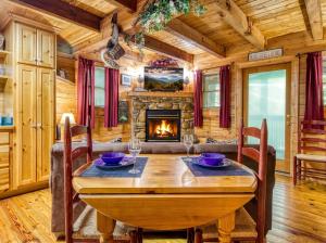 a dining room with a table and a fireplace at Precious Moments in Sevierville +21 photos