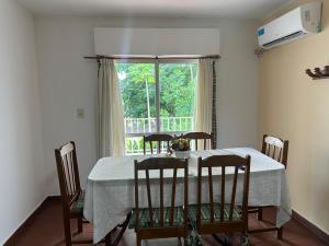a dining room table with four chairs and a window at Lass Cahuelas in Federación