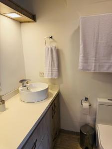 a white bathroom with a sink and a toilet at 2201 Hermoso apartamento poblado in Medellín +14 photos